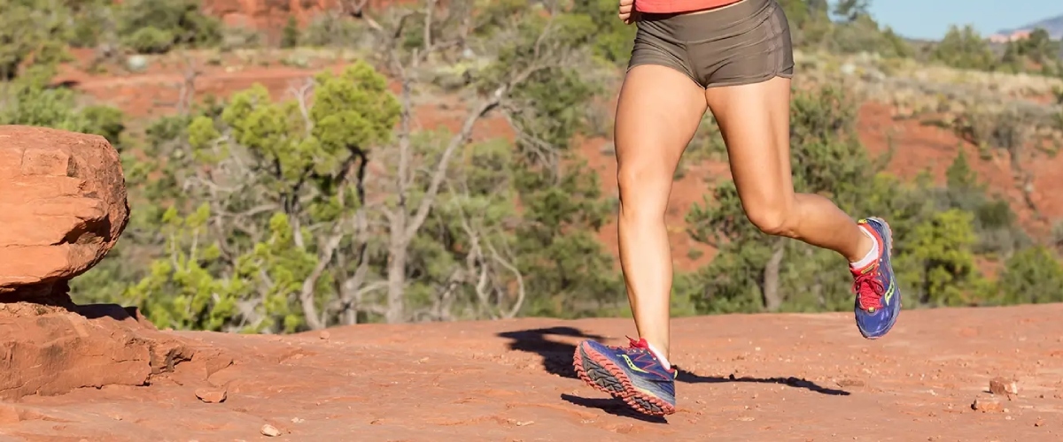 Individual running on Arizona trail, showcasing healthy joint mobility. Desert Spine and Sports Physicians supports active lifestyles.