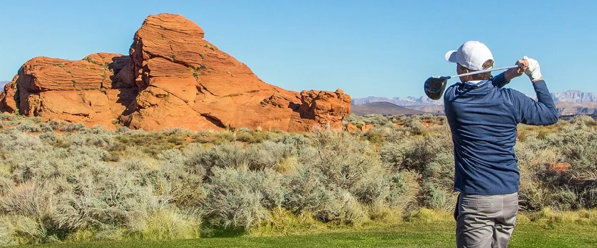 Man golfing in Arizona desert, showcasing spine health and mobility. Trust Desert Spine and Sports Physicians for expert care.