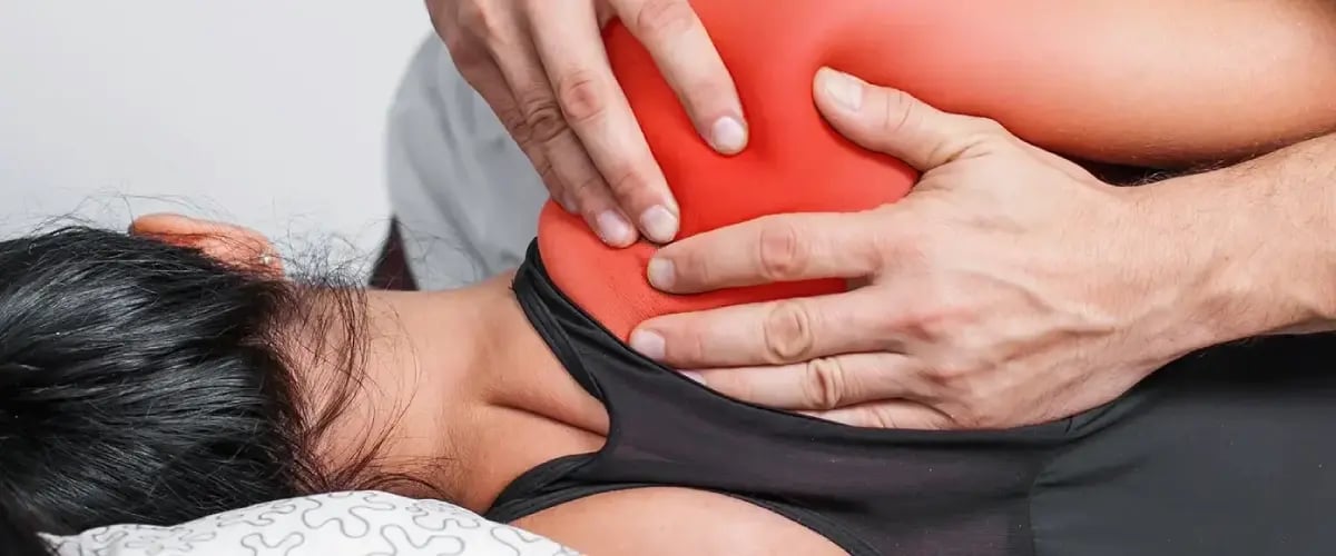 Physician treats shoulder pain at Desert Spine and Sports Physicians, Arizona. Professional care for musculoskeletal relief.
