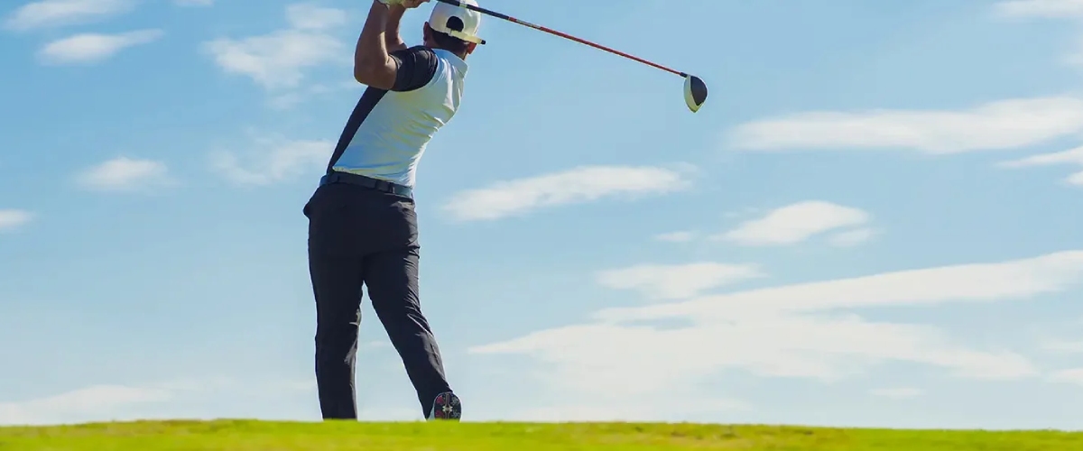 Person playing golf, highlighting spine health. Optimize your mobility with Desert Spine and Sports Physicians, Arizona specialists.