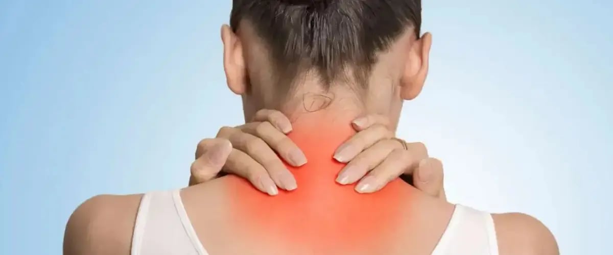 Person holds neck with red area, indicating pain. Visit Desert Spine and Sports Physicians in Arizona for relief.