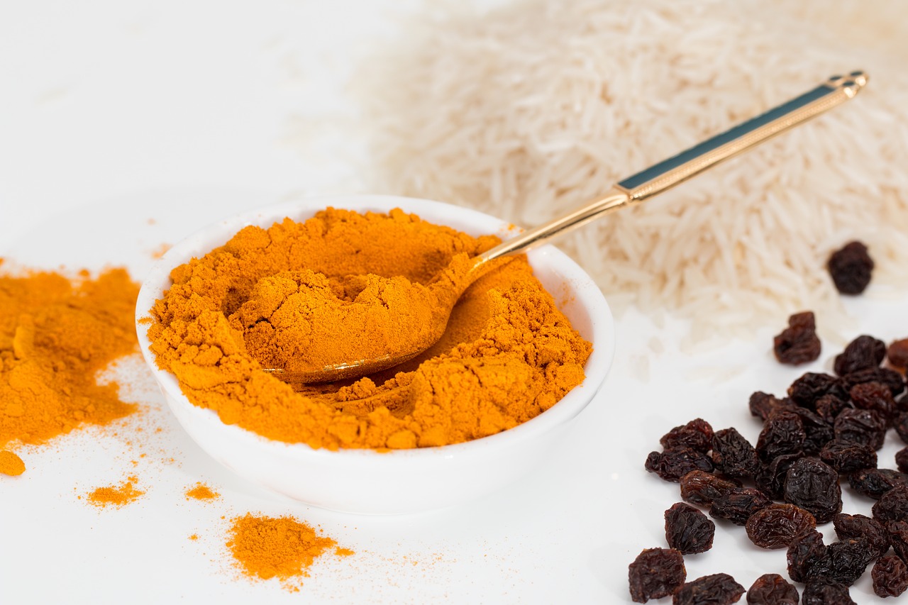 Turmeric Is it the Wonder Drug for Arthritis? - small bowl with turmeric powder and a spoon