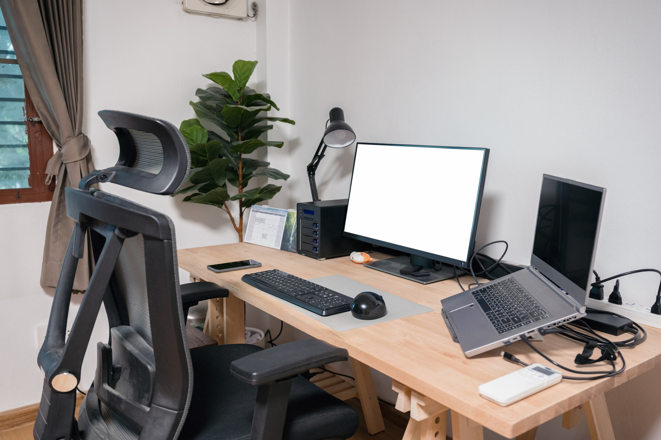A picture of a desk that has an ergonomic chair and a monitor
