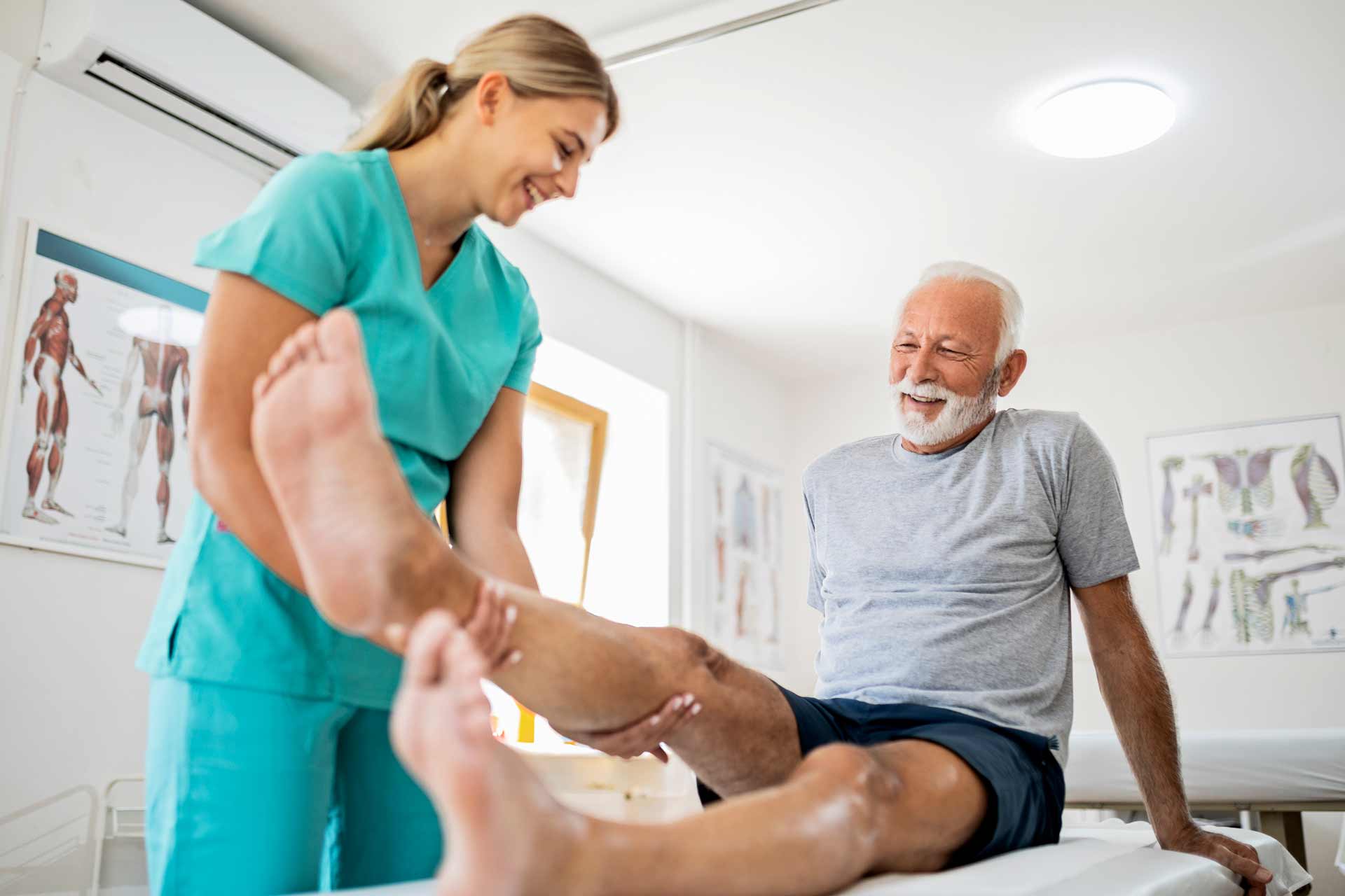 senior men with knee pain receiving physical therapy from a physician